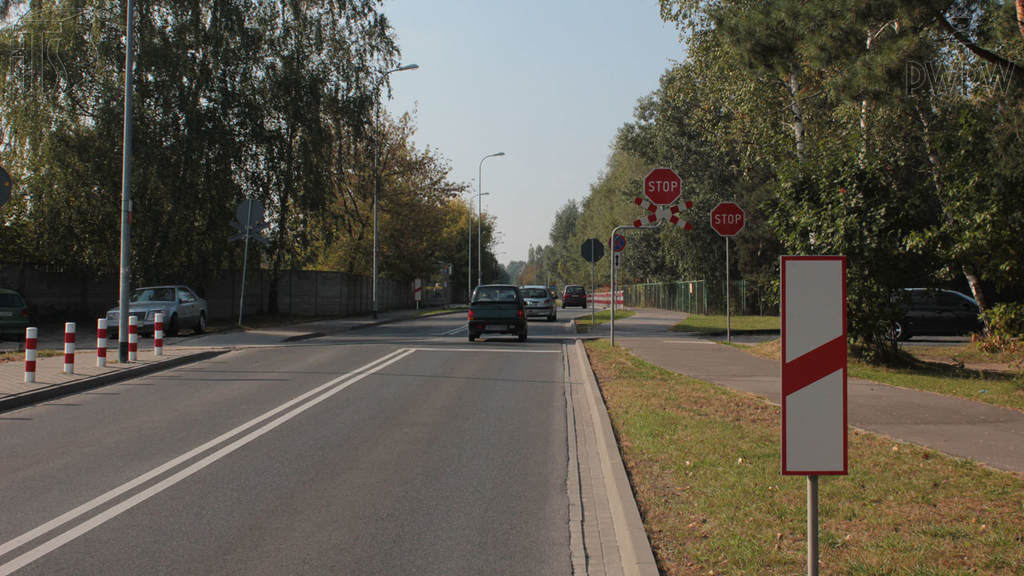 zdjecie do pytania - Czy postój pojazdu bezpośrednio za widocznym słupkiem wskaźnikowym jest zabroniony?